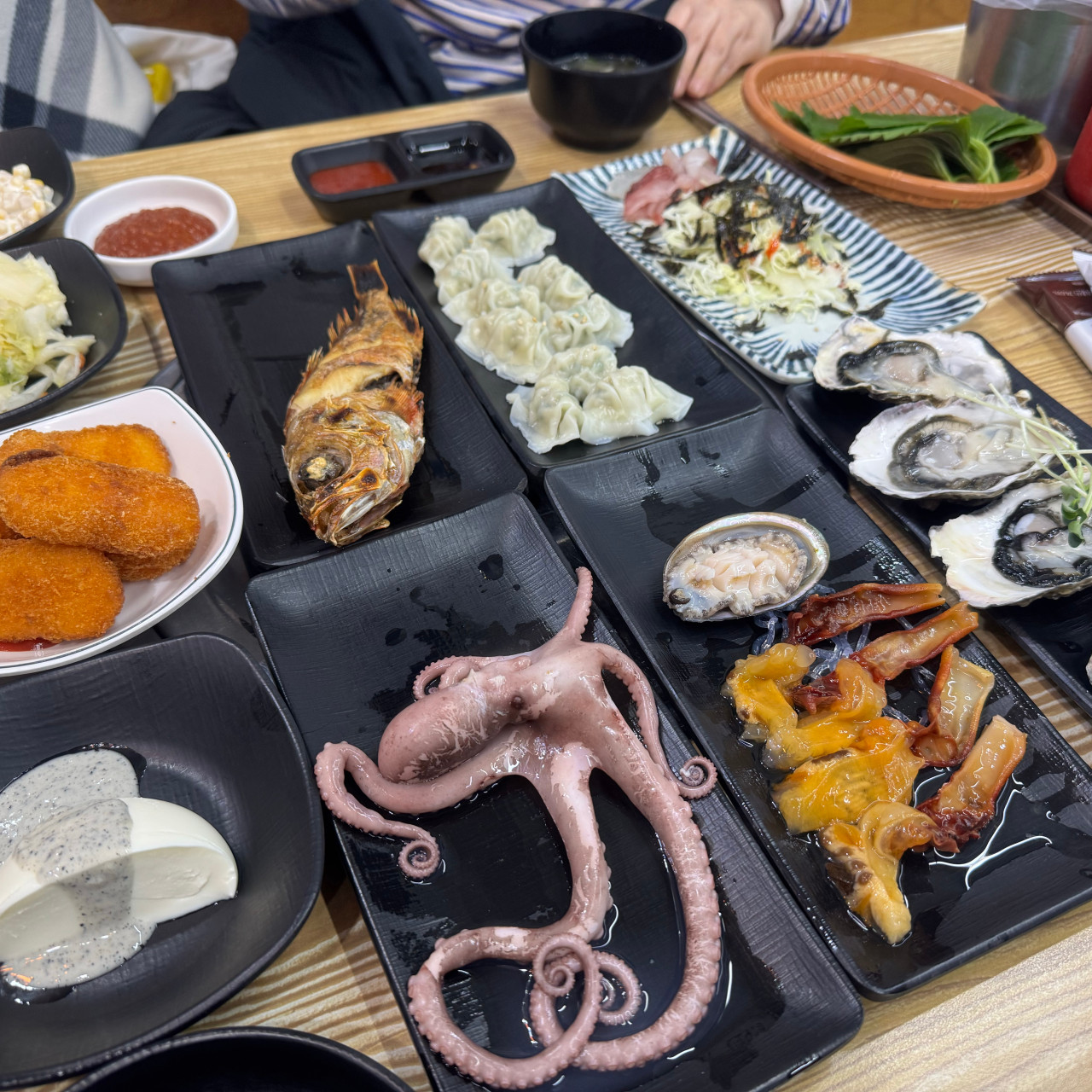 Assortment of side dishes at Haengbok Susan