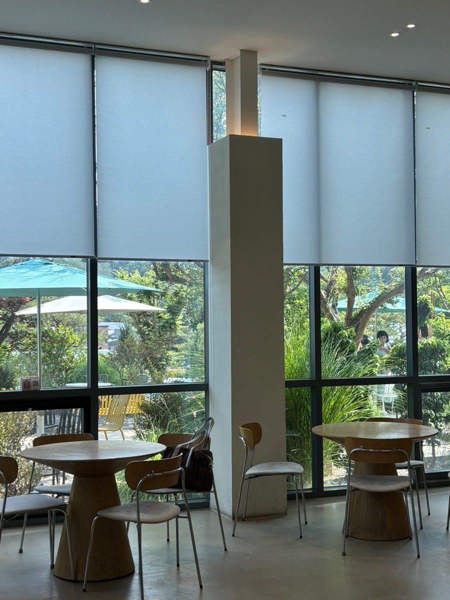 Cafe Interior - Interior with a sense of openness due to high ceilings and glass windows